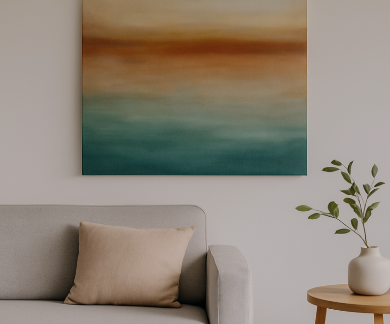 A modern living room with a gradient abstract painting hung above a light grey sofa, illustrating ideal wall art size and placement.